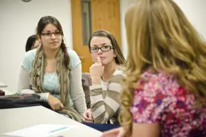 Students listening in class to their teacher