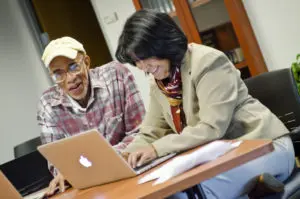 Faculty member helping student having happy conversation