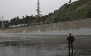 Student standing in flooded aread