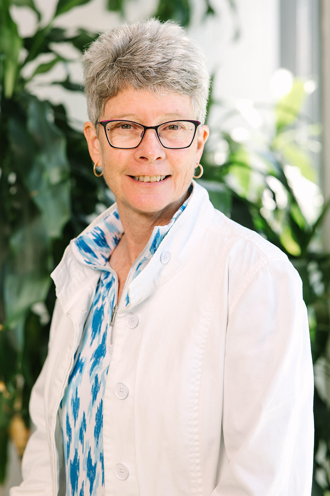 A portrait of Mary Ann Short, in front of a nondescript green and white background.