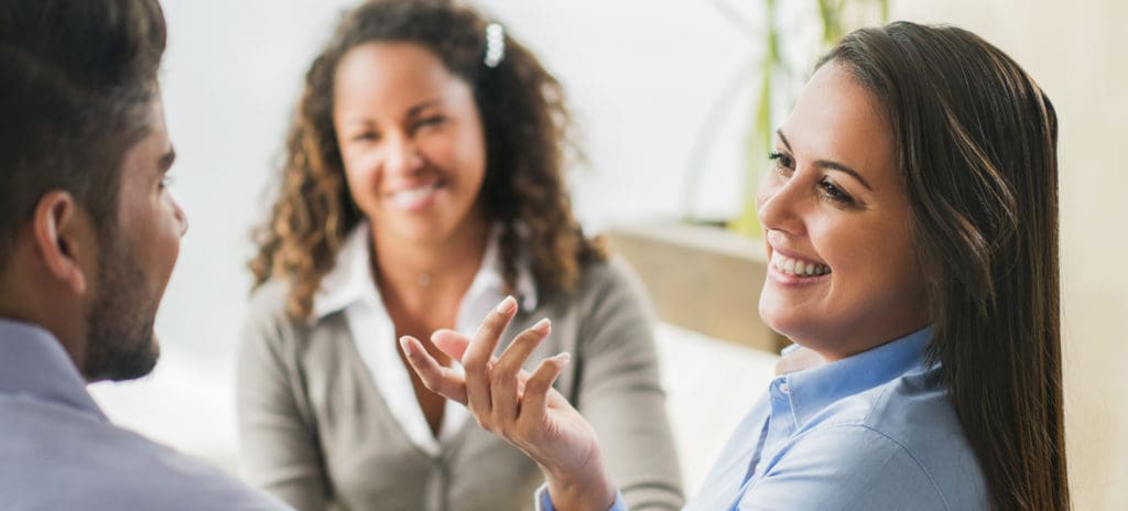 Group of three business people talking