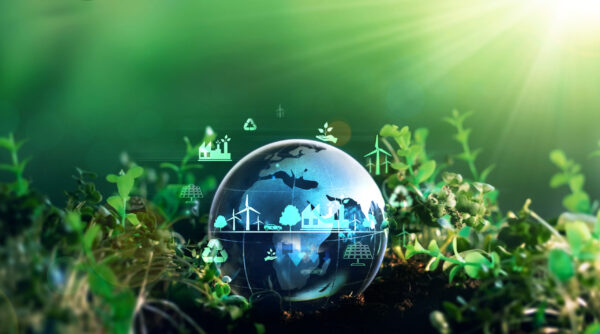 Green grass in background with a blue green water bubble with environmental symbols in the bubble.